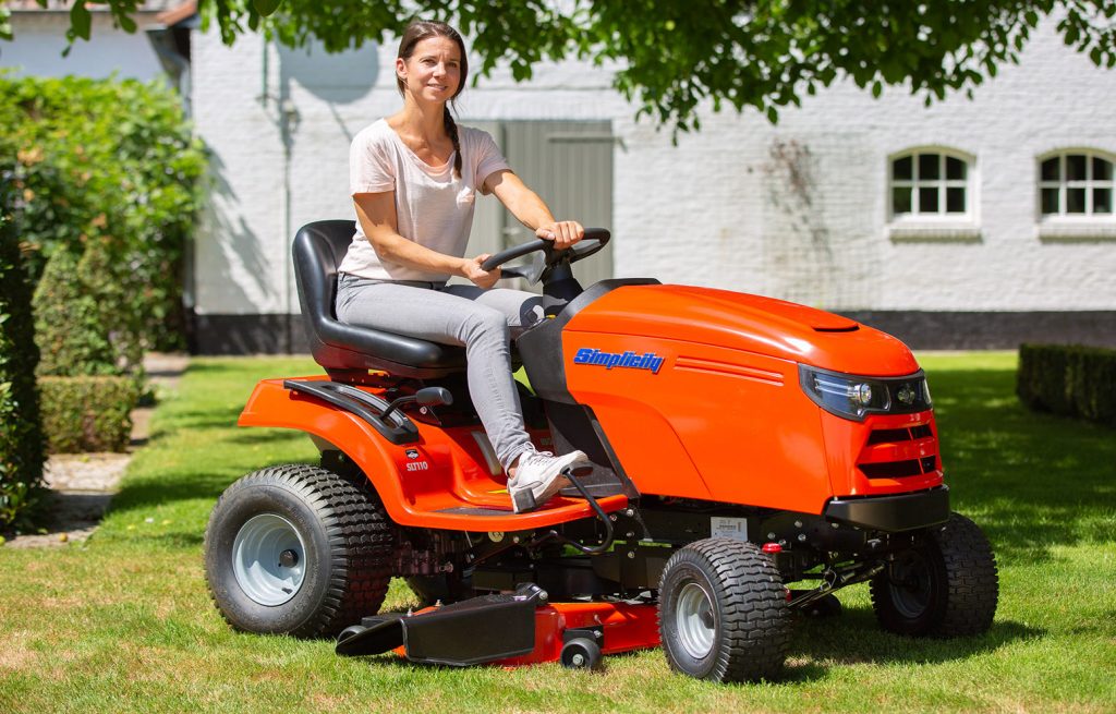 Woman driving ride on lawnmower