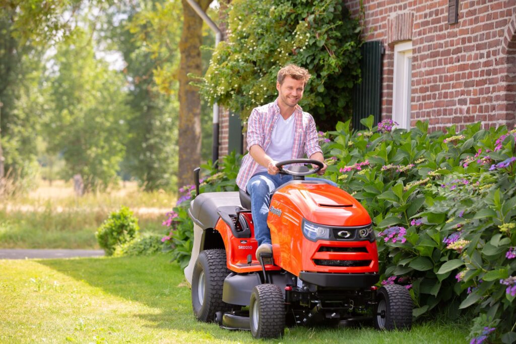 man driving ride-on lawnmower